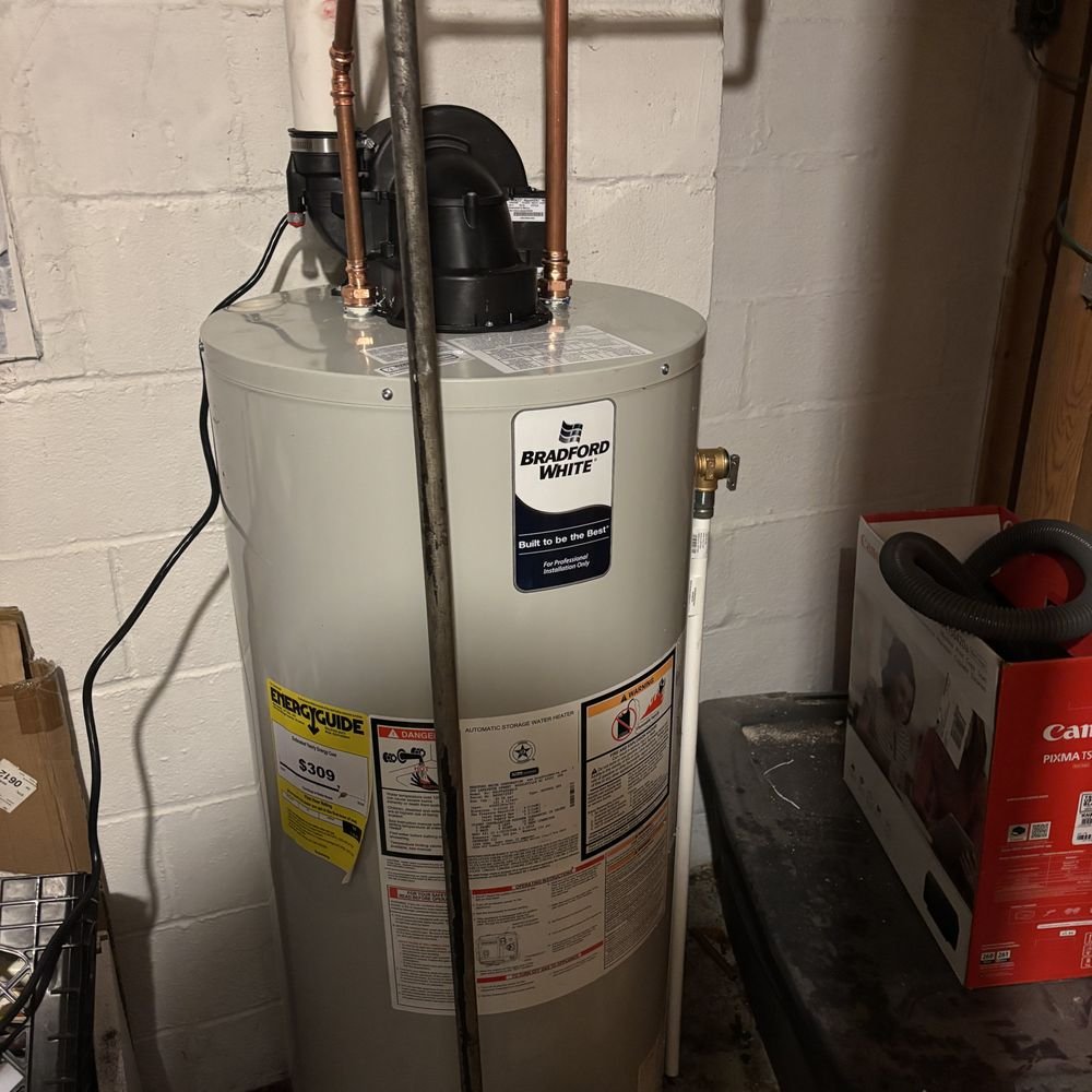 Skilled technician testing water heater components and confirming safe operating performance indoors