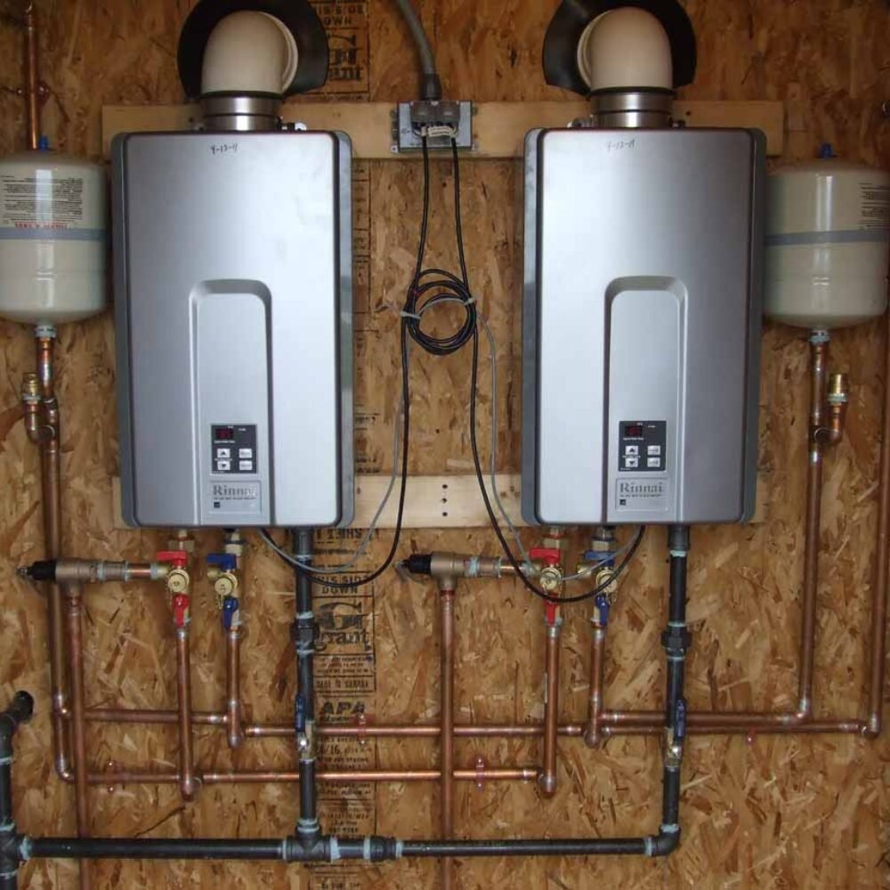 Technician replacing aging water heater in Greenwood laundry room after morning hot water failure